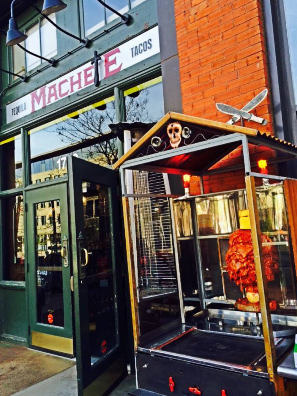 Restaurant entrance with outdoor taco grill.
