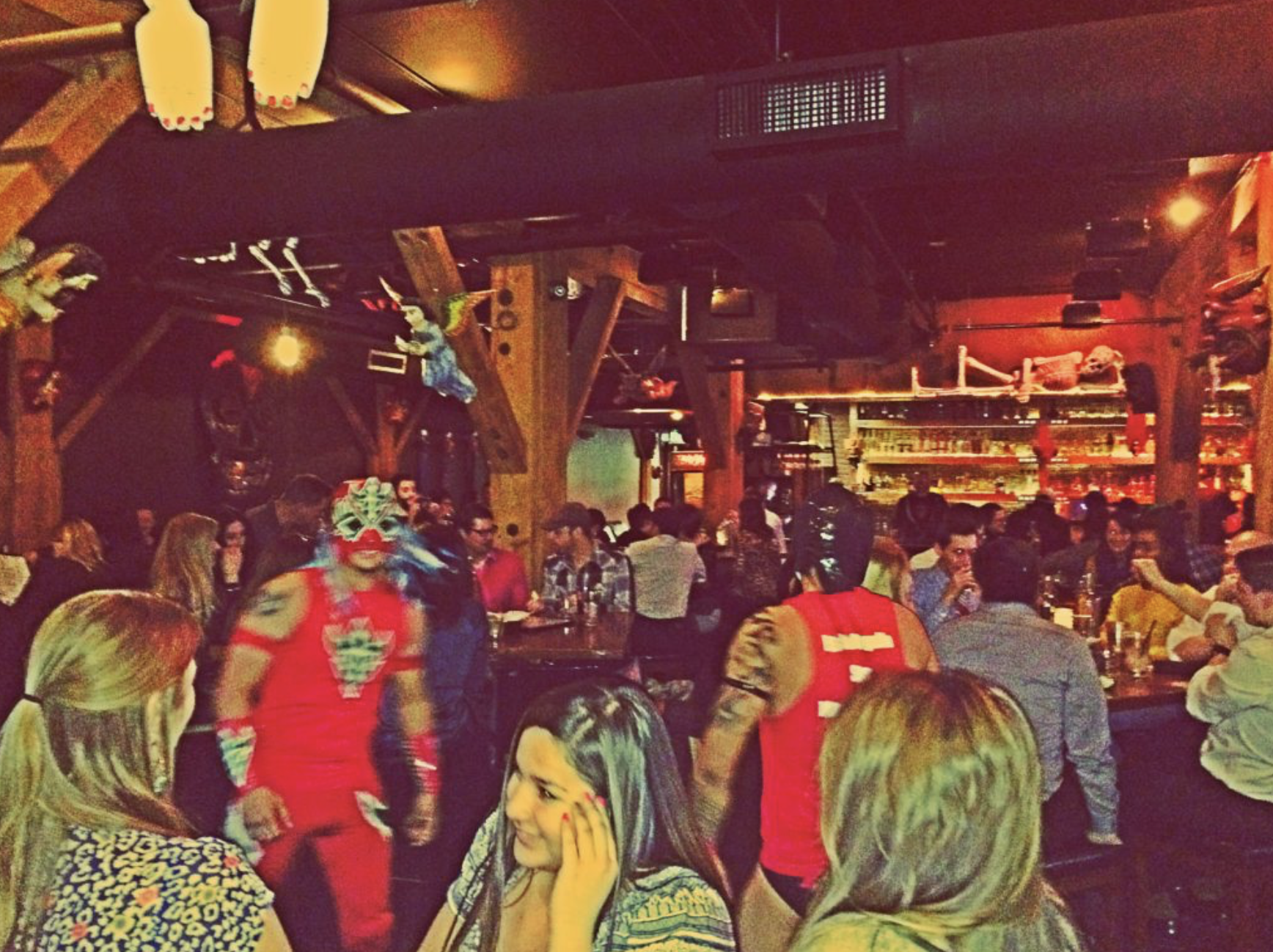 Crowded bar with people in costumes.